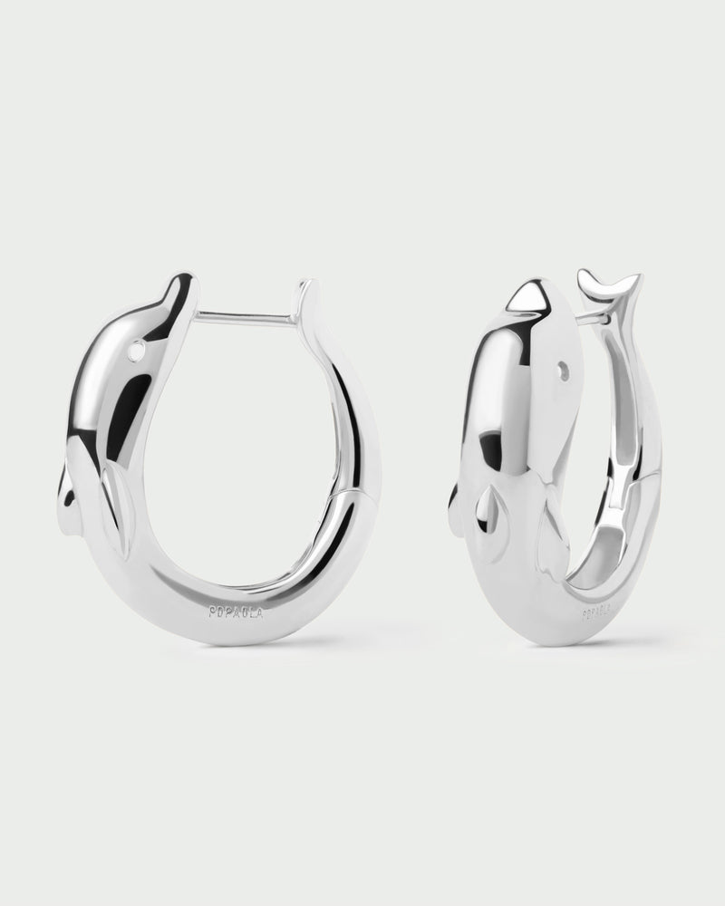 Silver modern large dolphin hoops with a sculptural shape