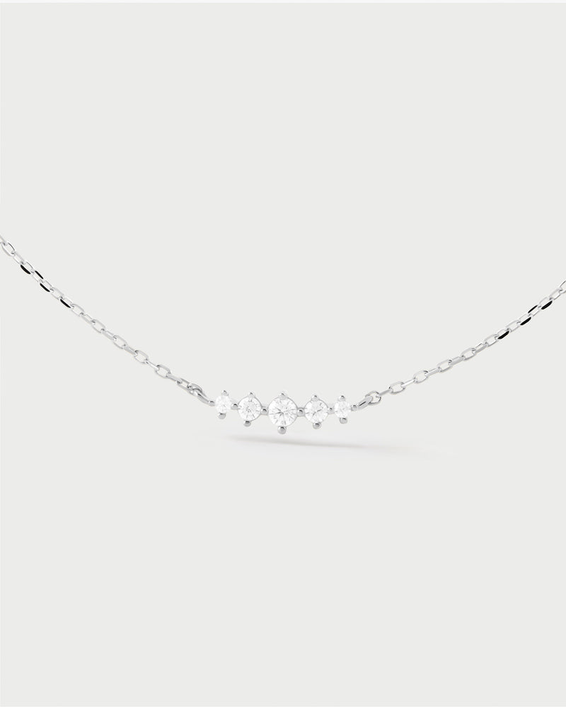 Elegant silver necklace set with a trail of five white zirconia