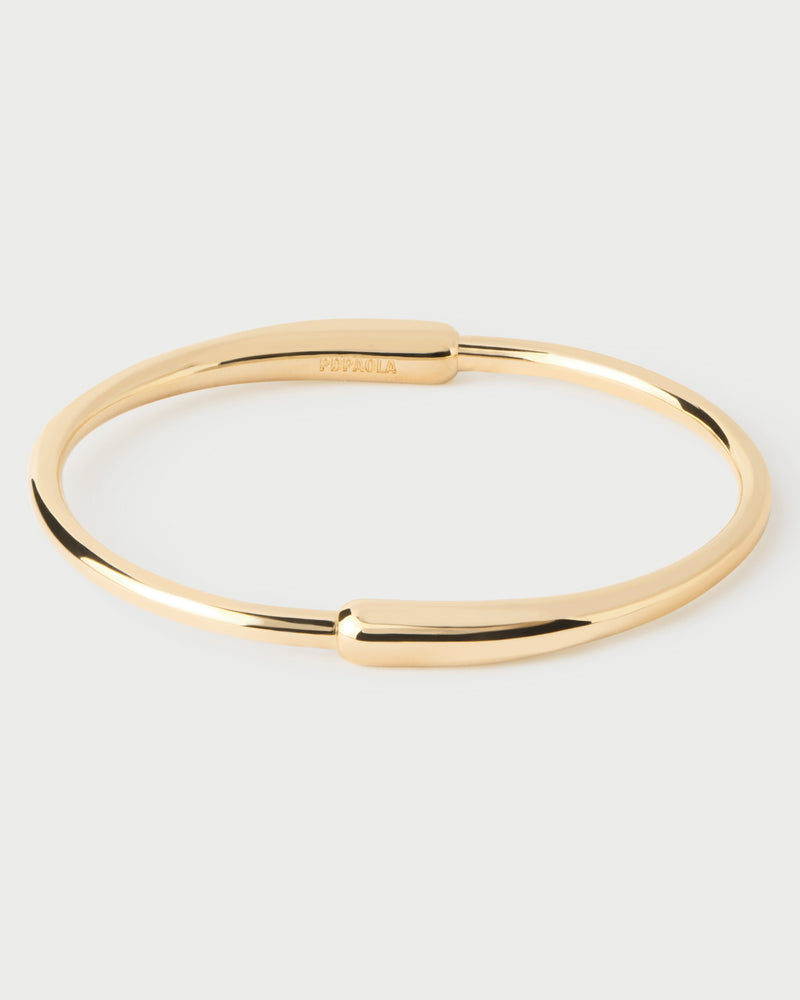 Modern bangle with asymmetric design featuring two elonganted drop-shaped motifs