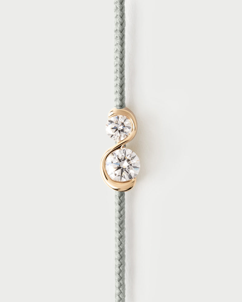 Adjustable diamond cord bracelet featuring two lab-grown diamonds