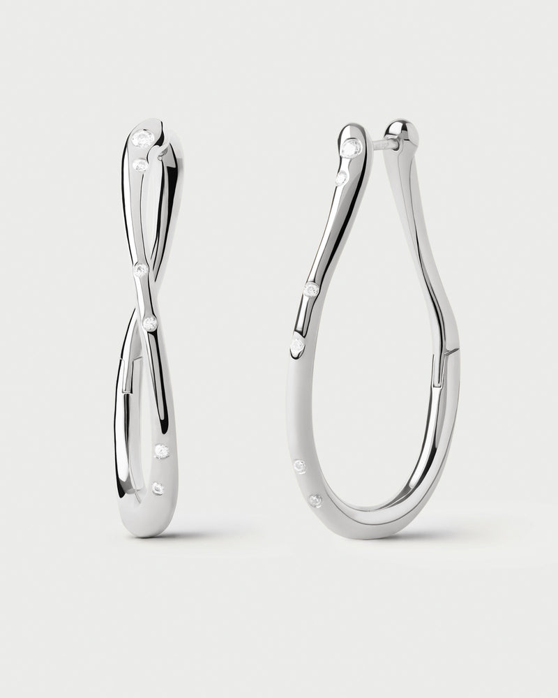 Large wavy silver hoop earrings adorned with sparkling zirconia accents