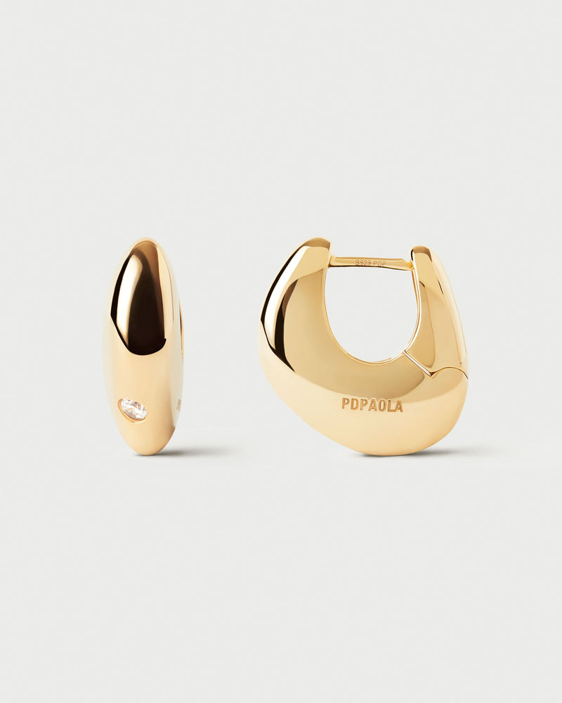 Sculptural hoop earrings with asymmetric design adorned with round white zirconia