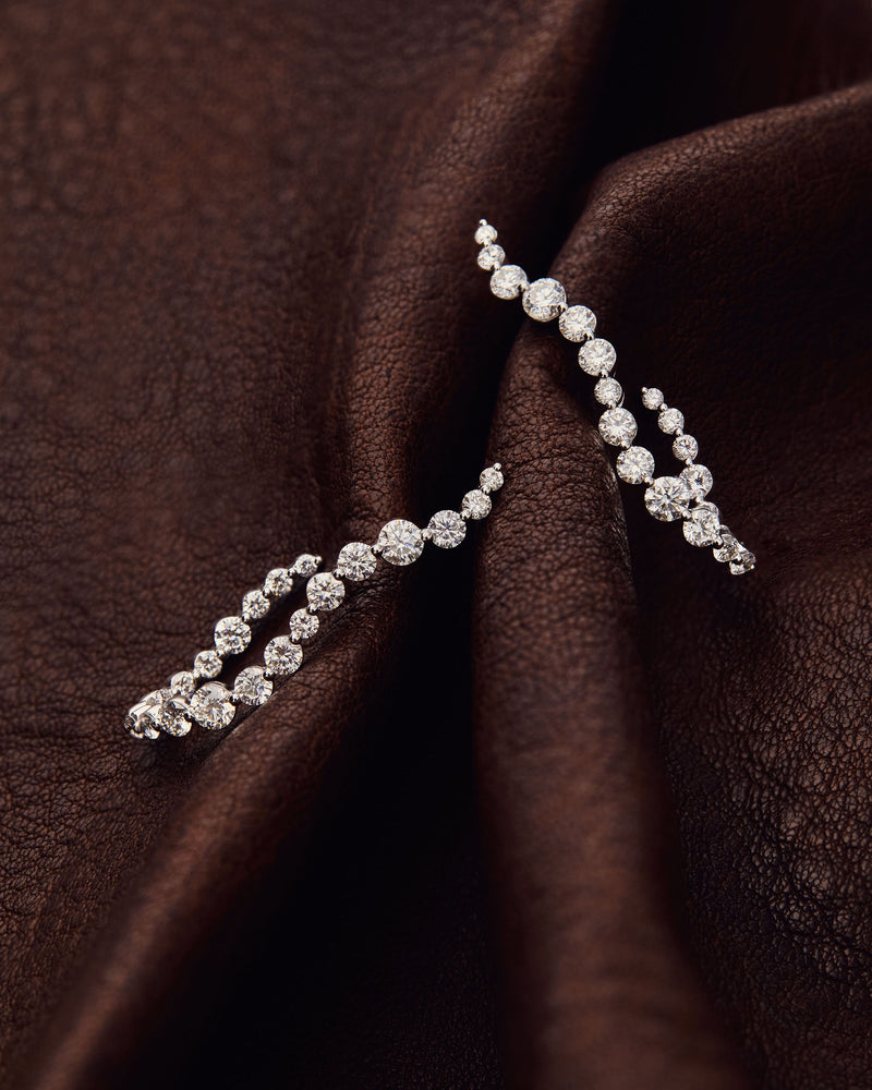 Elegant large semi hoops in 18K white gold featuring an undulating line of lab-grown diamonds