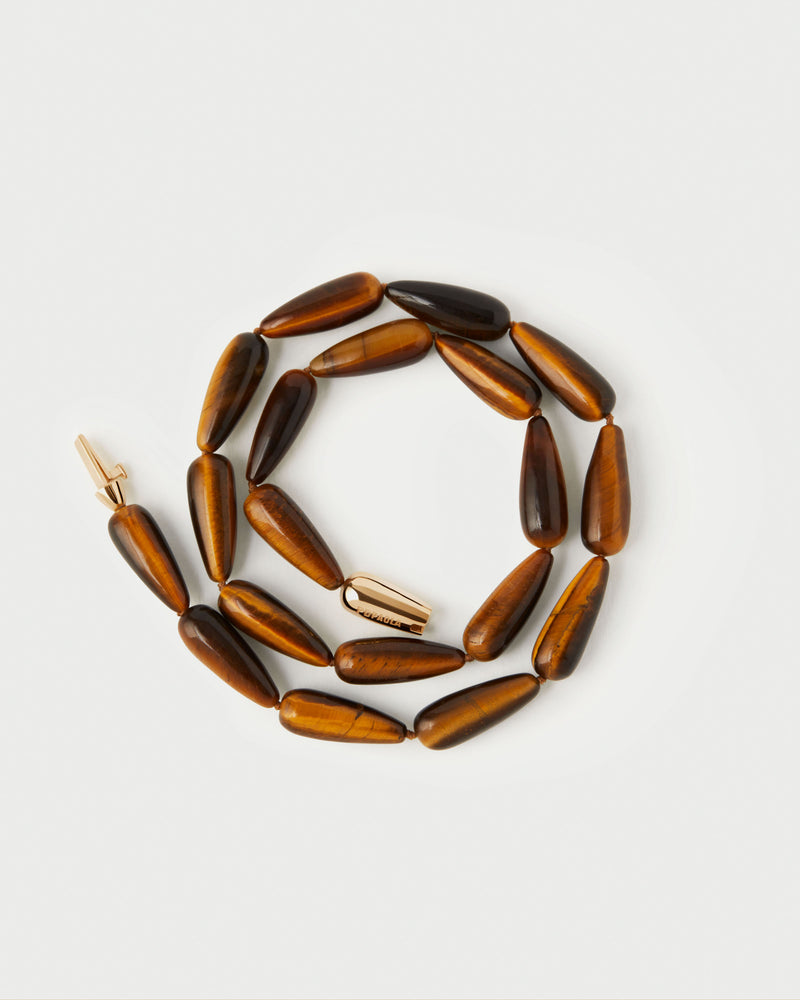 Modern choker featuring brown gemstone beads and signature drop closure