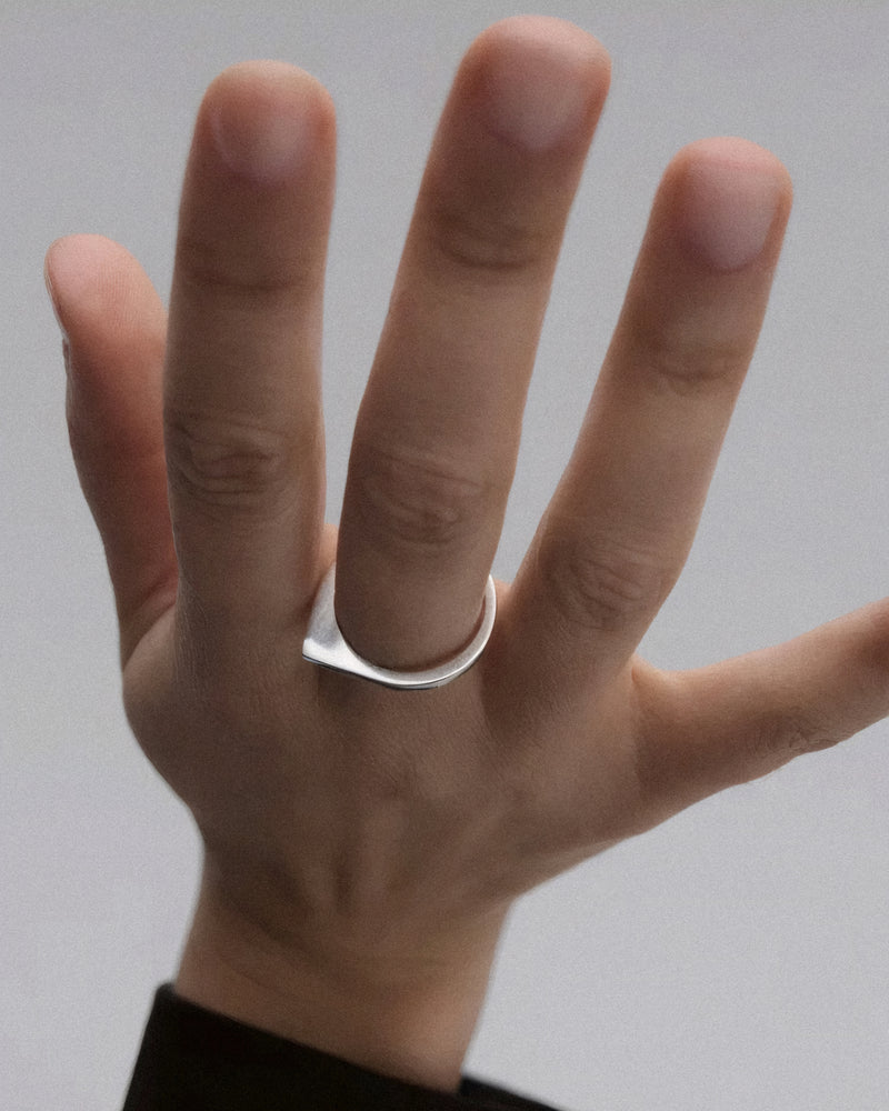 Silver geometric ring with asymmetric round shape