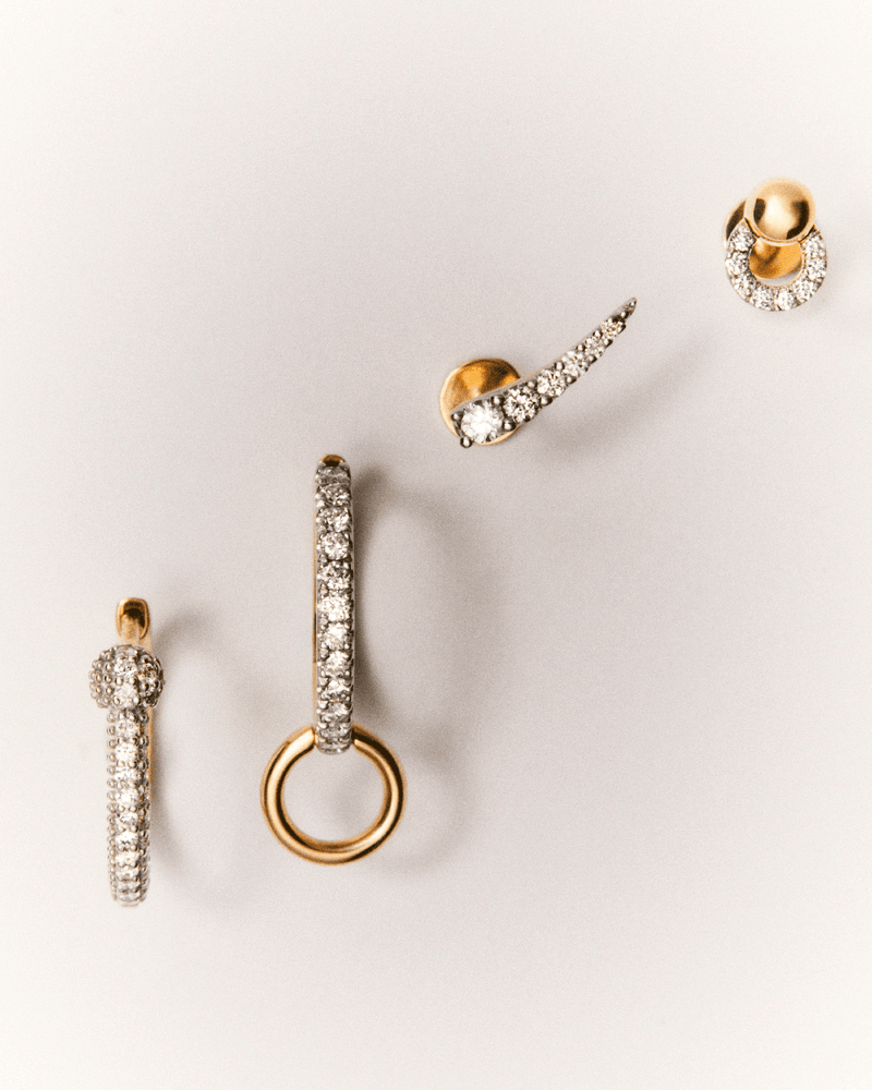 Minimalist single earring in solid yellow gold set with an oval shape pavé lab-grown diamond